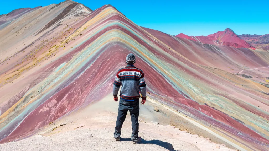 A happy group of travelers enjoying a premium gourmet breakfast with a mountain view during a guided tour