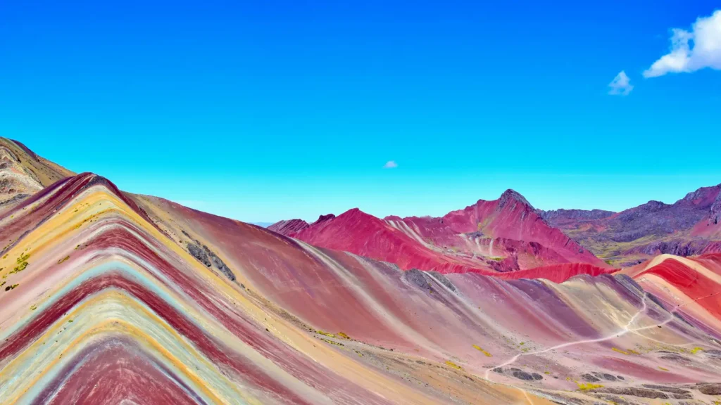 Close-up of the sedimentary layers showing red, yellow, and turquoise minerals