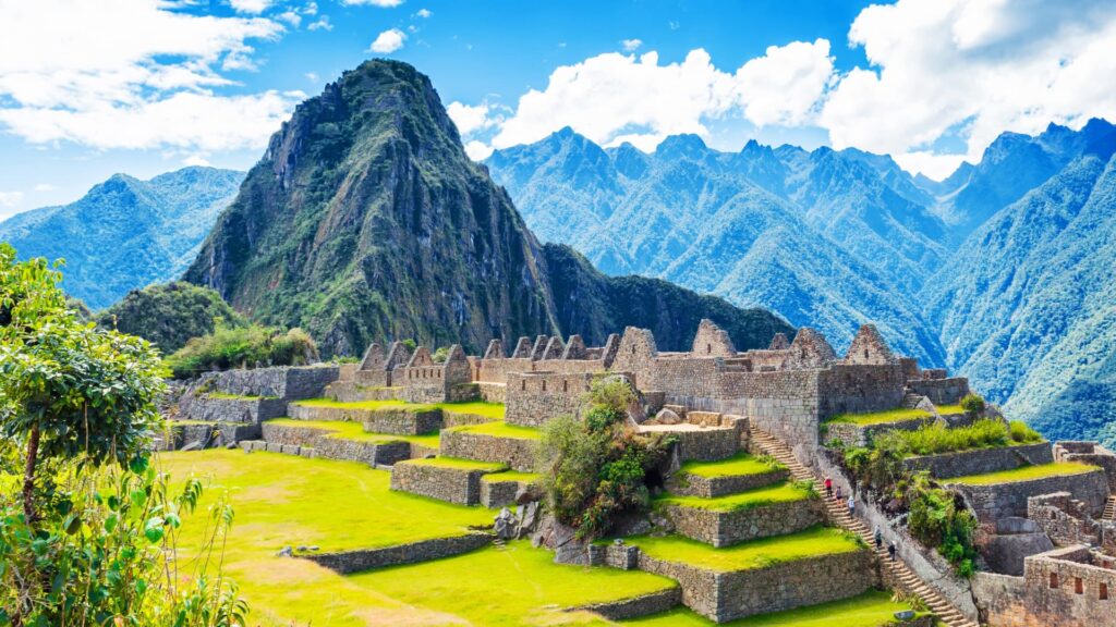 Detailed side perspective of the ancient stone structures at Machu Picchu under clear morning skies
